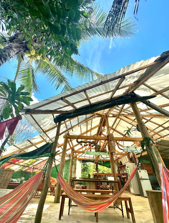 a couple of hammocks in front of a building at Lazy Bones in Koh Rong Sanloem