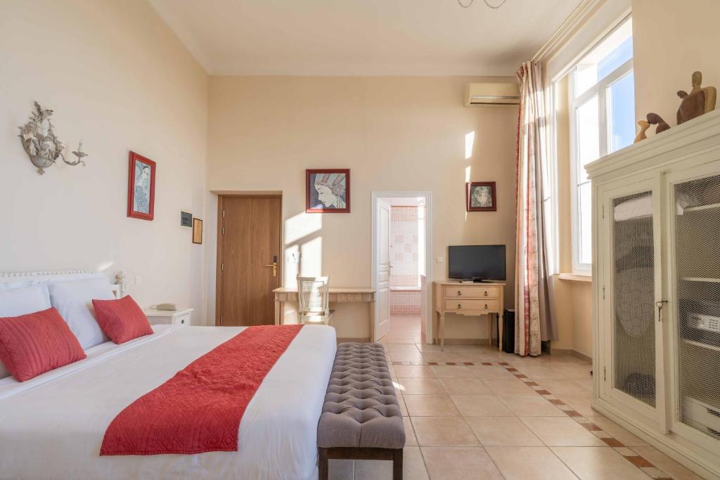 Postel nebo postele na pokoji v ubytování Hôtel l'Orangeraie