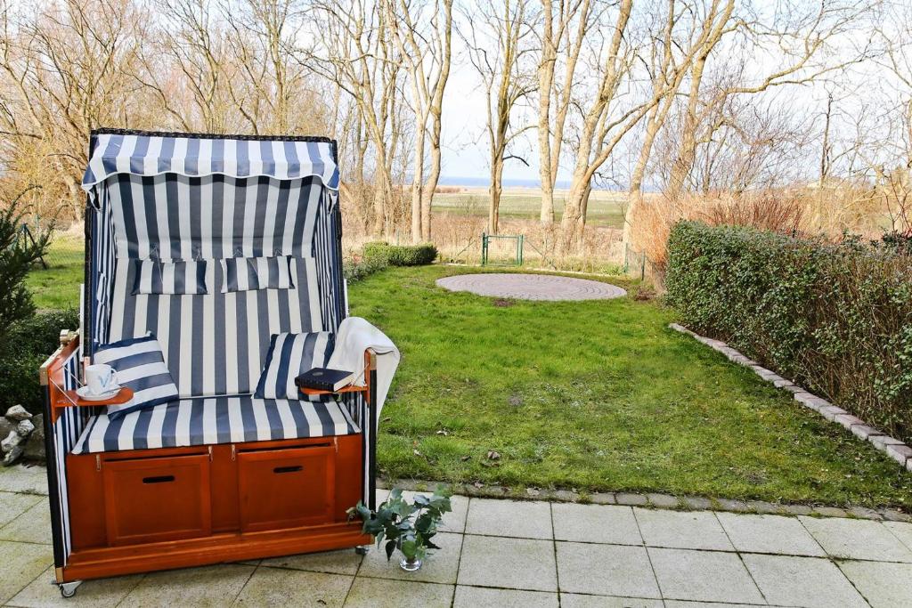 a chair sitting on a patio in a yard at Landhaus zum Strande - 44-08 in Kägsdorf