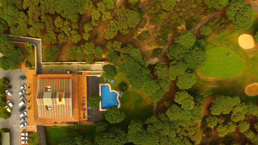 an overhead view of a house in a forest at Hotel Nuevo Portil Golf in El Rompido
