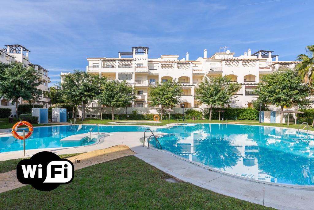 a large swimming pool in front of a large building at Residencial Duquesa 18 in Manilva