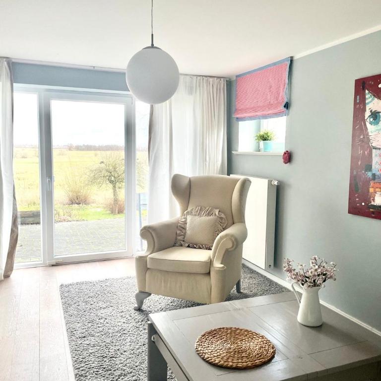 a living room with a chair and a table at Kleine Auszeit auf Halbinsel Holnis in Holnis
