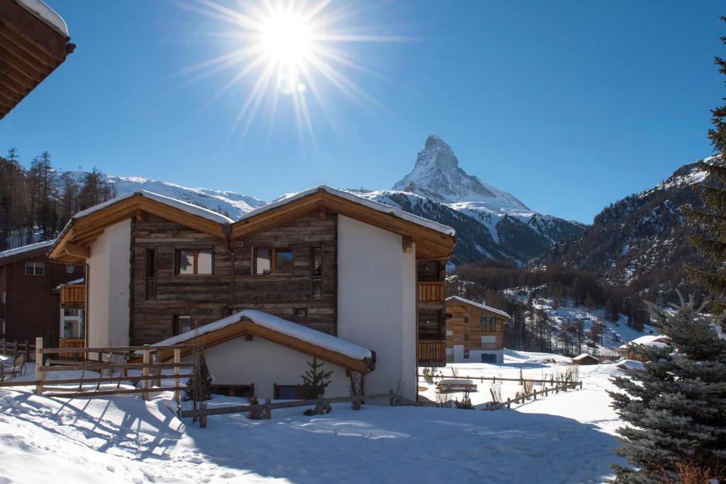 a log cabin in the snow with a mountain at Chalet Shalimar in Zermatt