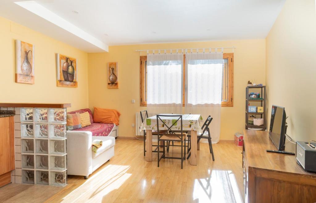 a living room with a couch and a table at Apartament a Gombrèn Girona amb vistes a la natura in Gombreny