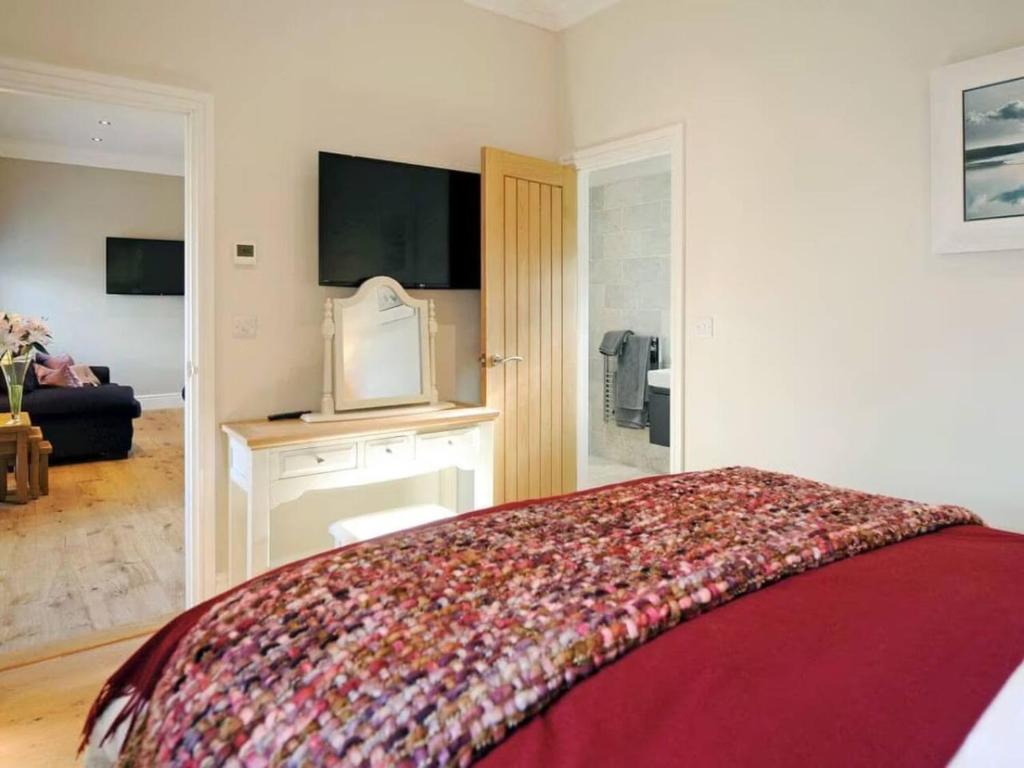 een slaapkamer met een bed en een woonkamer bij Chic Clock Tower with Gardens Close to Beaches in Johnston