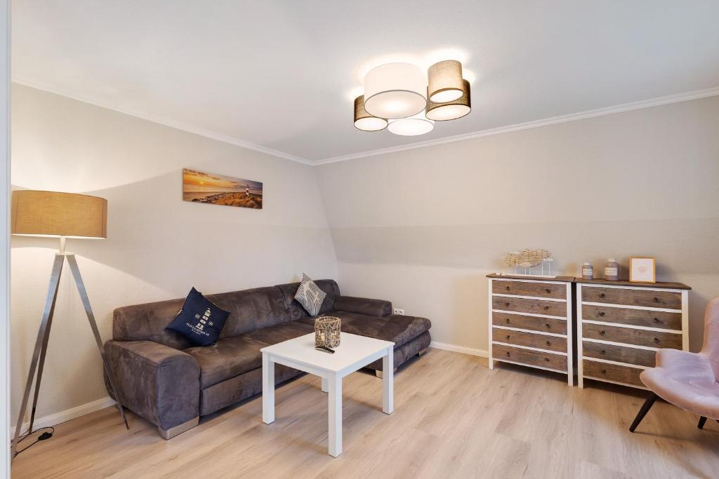 a living room with a couch and a table at Ferienwohnung Leuchtfeuer in Brodten