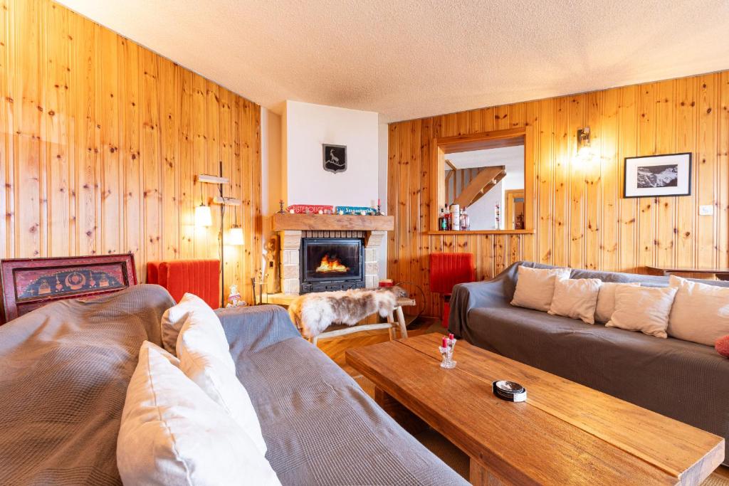 a living room with two couches and a fireplace at Haute Vue MOUNTAIN & VIEW chalet 14 pers in Veysonnaz