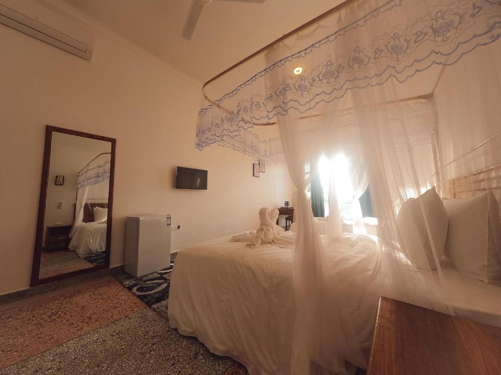 Postel nebo postele na pokoji v ubytování SeaBreeze Villas Nungwi