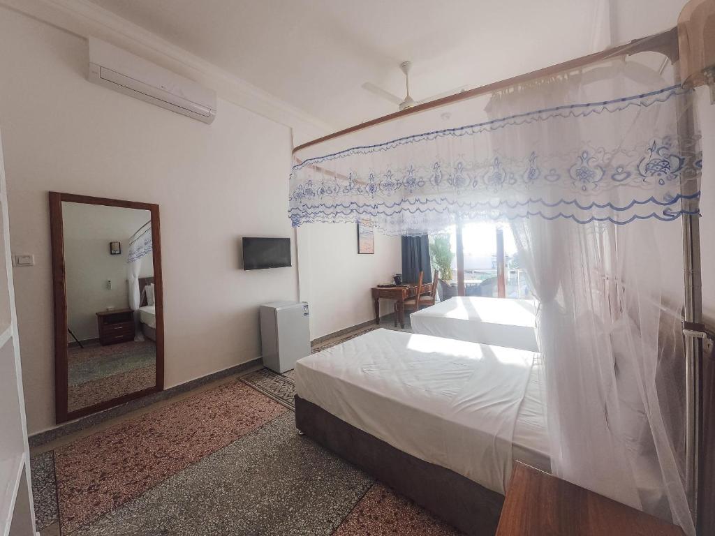 Postel nebo postele na pokoji v ubytování SeaBreeze Villas Nungwi