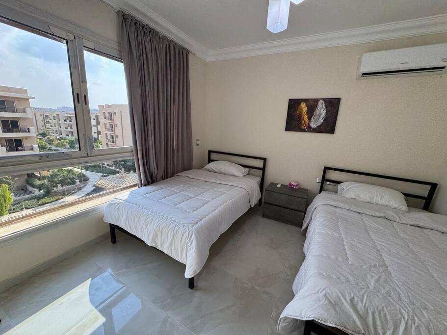 Postel nebo postele na pokoji v ubytování Modern Luxury Apartment - New Cairo
