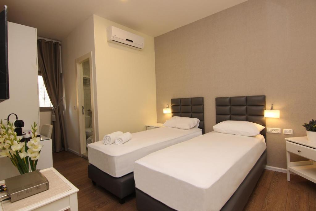 Postel nebo postele na pokoji v ubytování Idelson Hotel