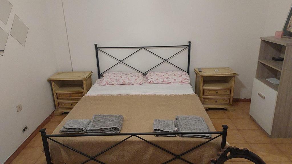a small bedroom with a bed with two night stands at Piccolo Appartamento Pdrone in Rome