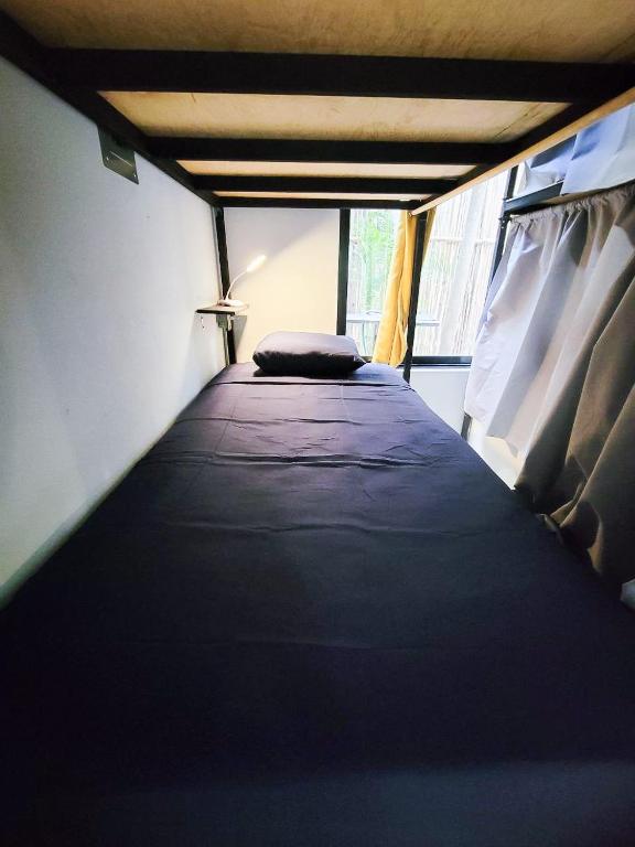 Postel nebo postele na pokoji v ubytování Maui Hostels Tulum