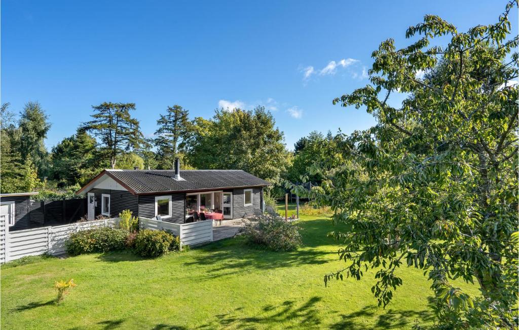 a cabin in the middle of a grassy yard at Awesome Home In Græsted With Wifi in Græsted