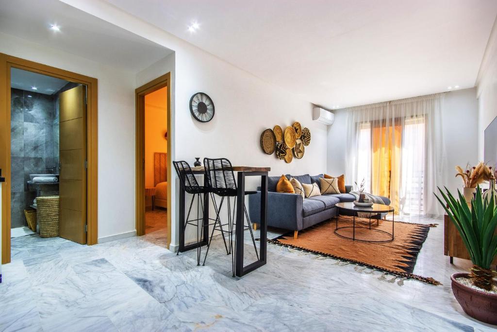 a living room with a couch and a table at Bohemian Style in hyper-center - Wifi in Marrakesh