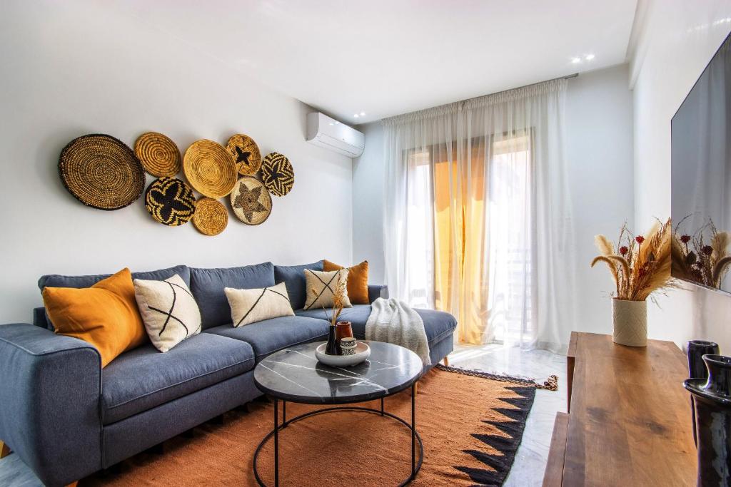a living room with a blue couch and a table at Bohemian Style in hyper-center - Wifi in Marrakesh