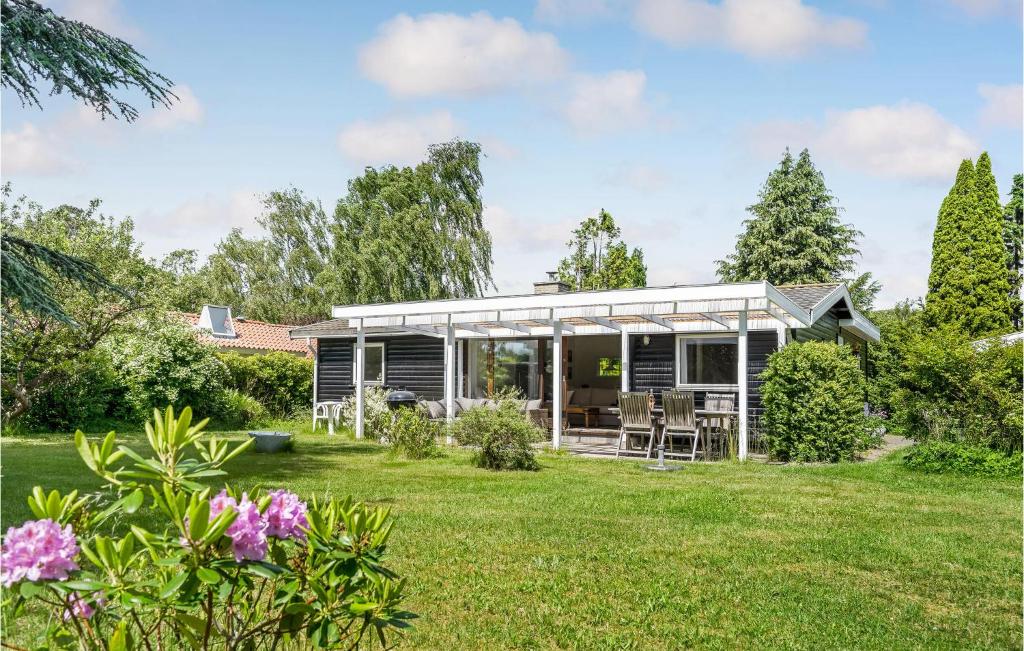 a house in the garden with a lawn at 2 Bedroom Beautiful Home In Gilleleje in Gilleleje