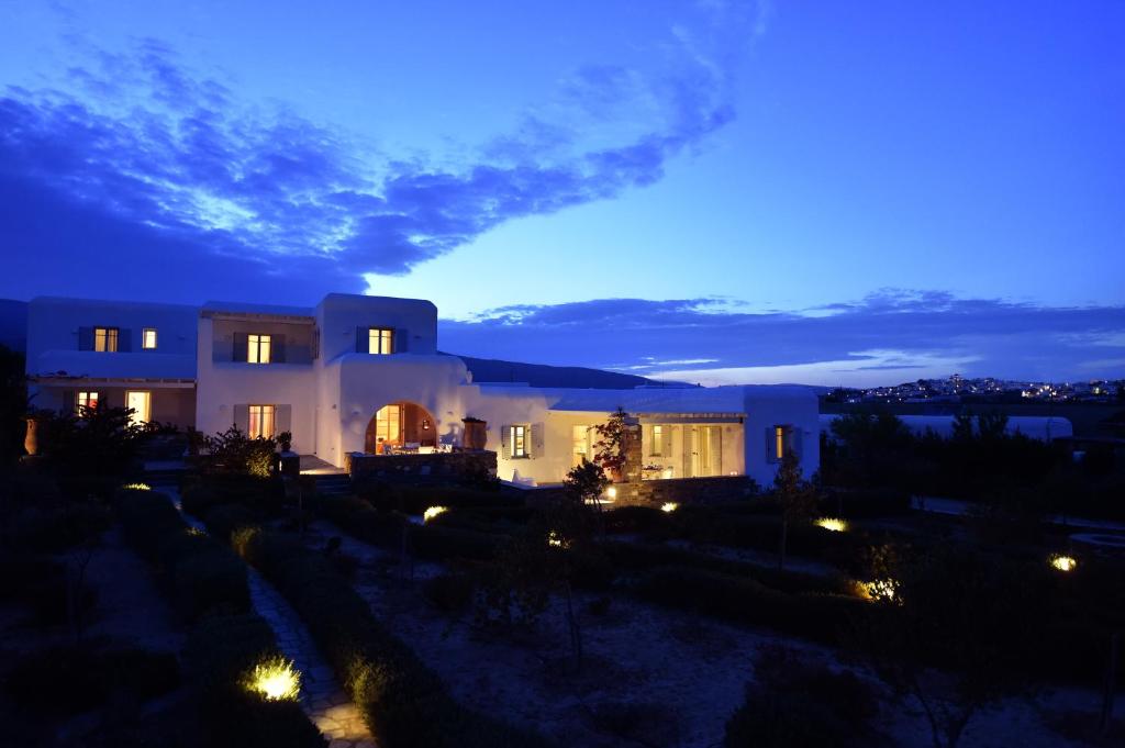 una casa iluminada por la noche con luces en Aspro Villas, en Piso Livadi
