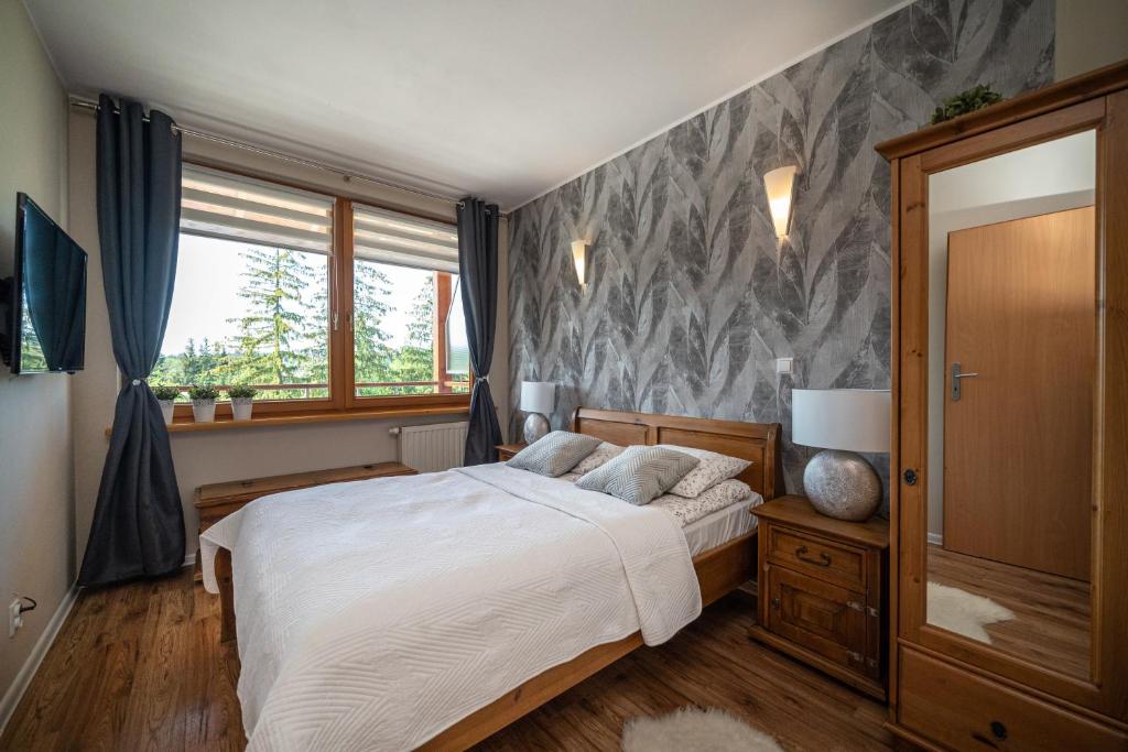 Posteľ alebo postele v izbe v ubytovaní Apartamenty Viva Maria Zakopane