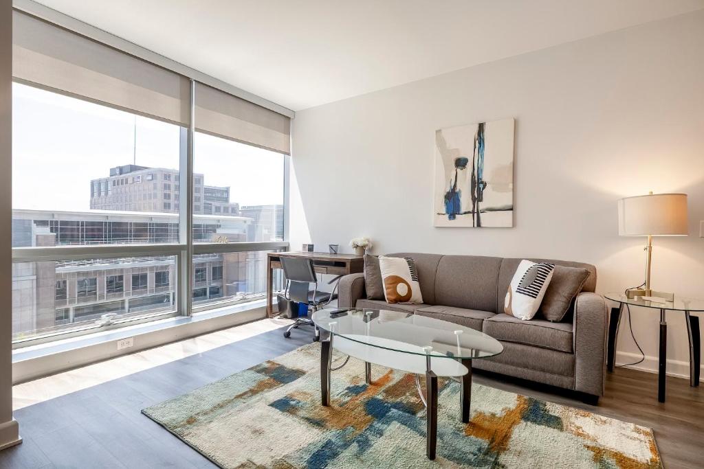 a living room with a couch and a table at Luxury Apt with Gym & Pool in Stamford