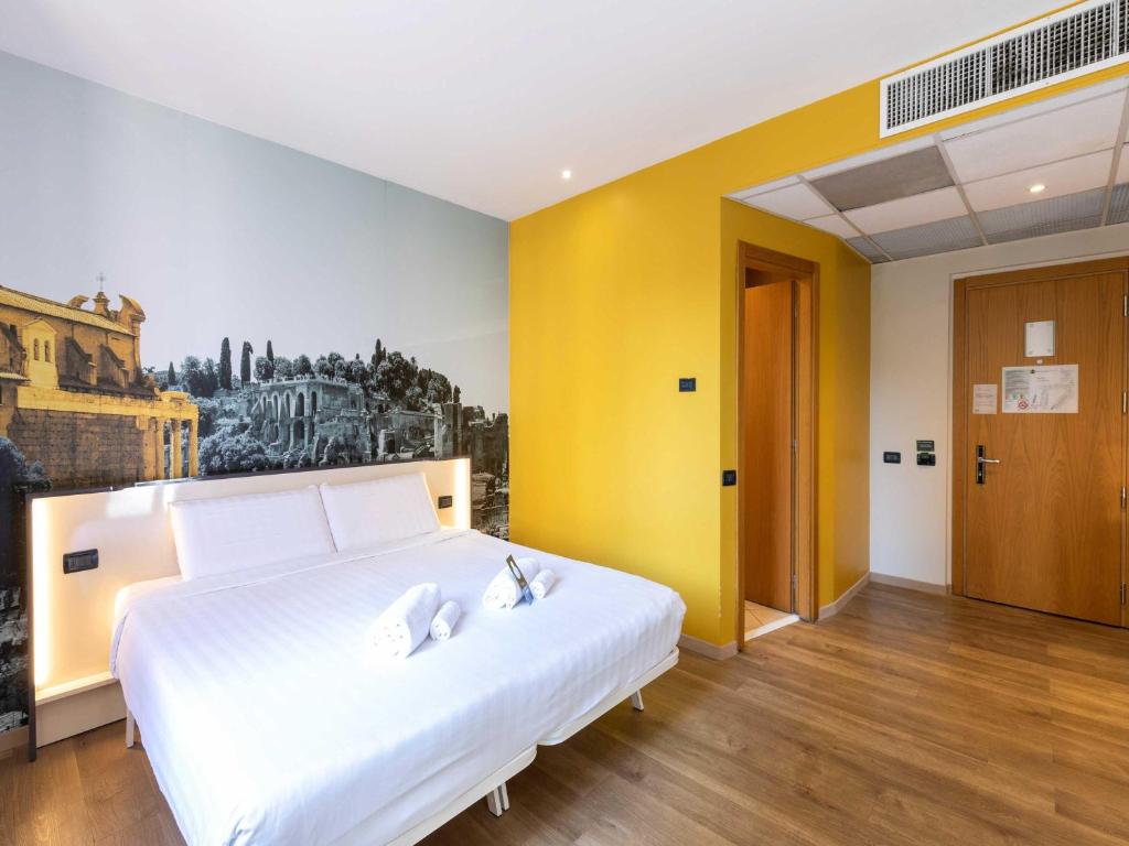 Postel nebo postele na pokoji v ubytování B&B Hotel Roma Tuscolana San Giovanni