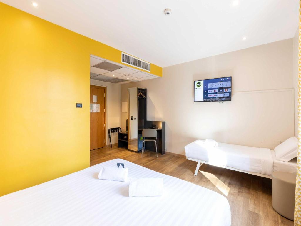 Postel nebo postele na pokoji v ubytování B&B Hotel Roma Tuscolana San Giovanni