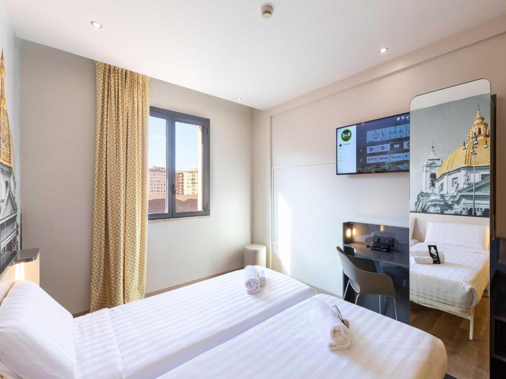 Postel nebo postele na pokoji v ubytování B&B Hotel Roma Tuscolana San Giovanni