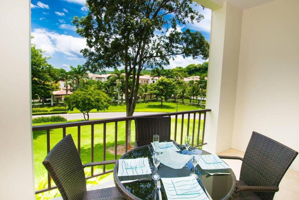 a dining room with a table and chairs on a balcony at Chic Minimalist Condo with Swimming Pool, Hot Tub, and Beach Club Access in Coco
