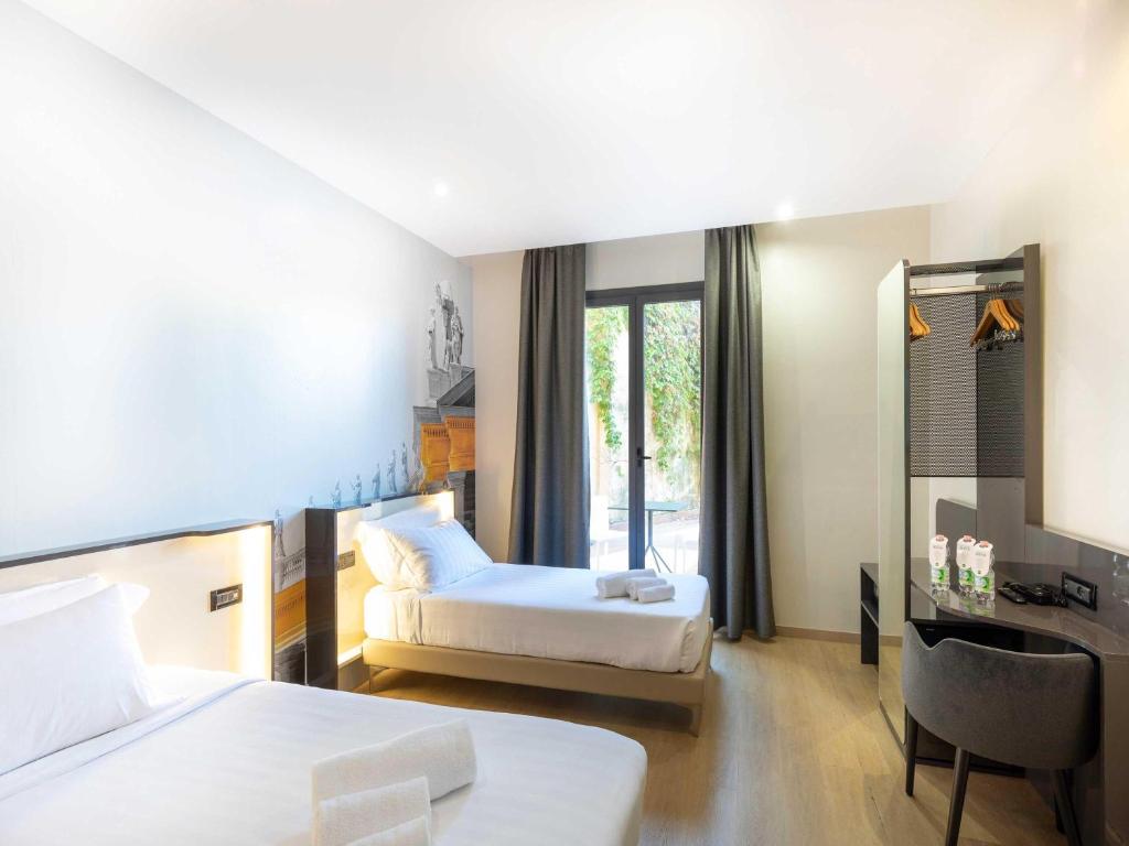 Postel nebo postele na pokoji v ubytování B&B Hotel Roma Tuscolana San Giovanni
