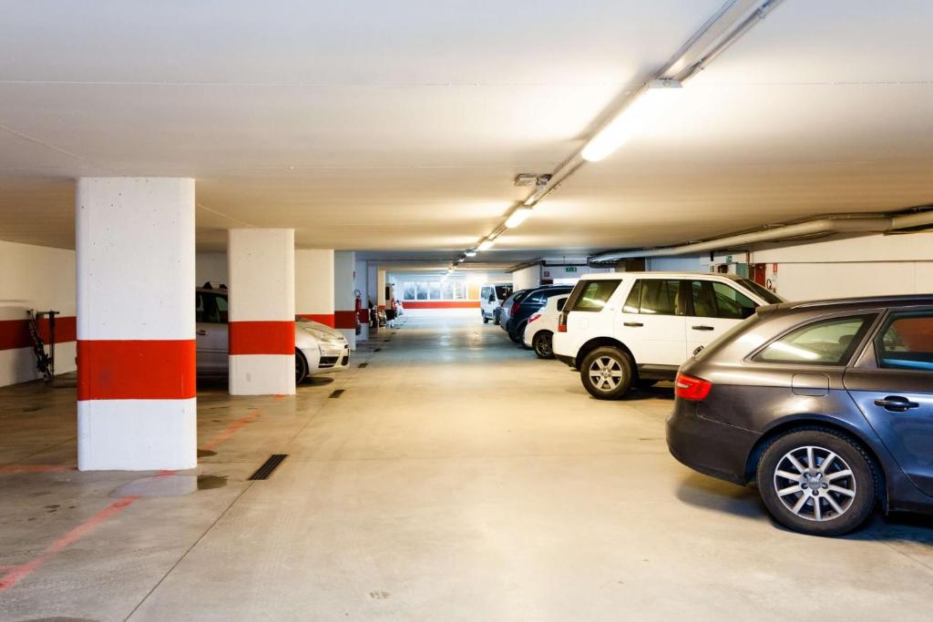 a parking garage with cars parked in it at Hotel Vienna in San Martino di Castrozza