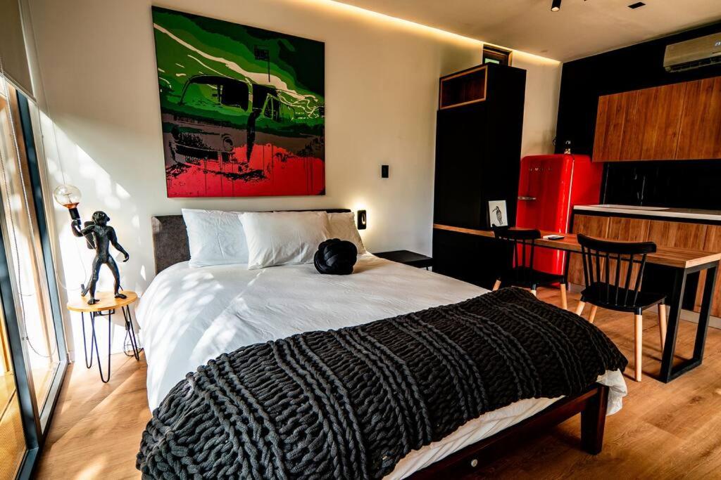 a bedroom with a bed with a black and white blanket at Tiny House by HYTTE HOMES in Panama City