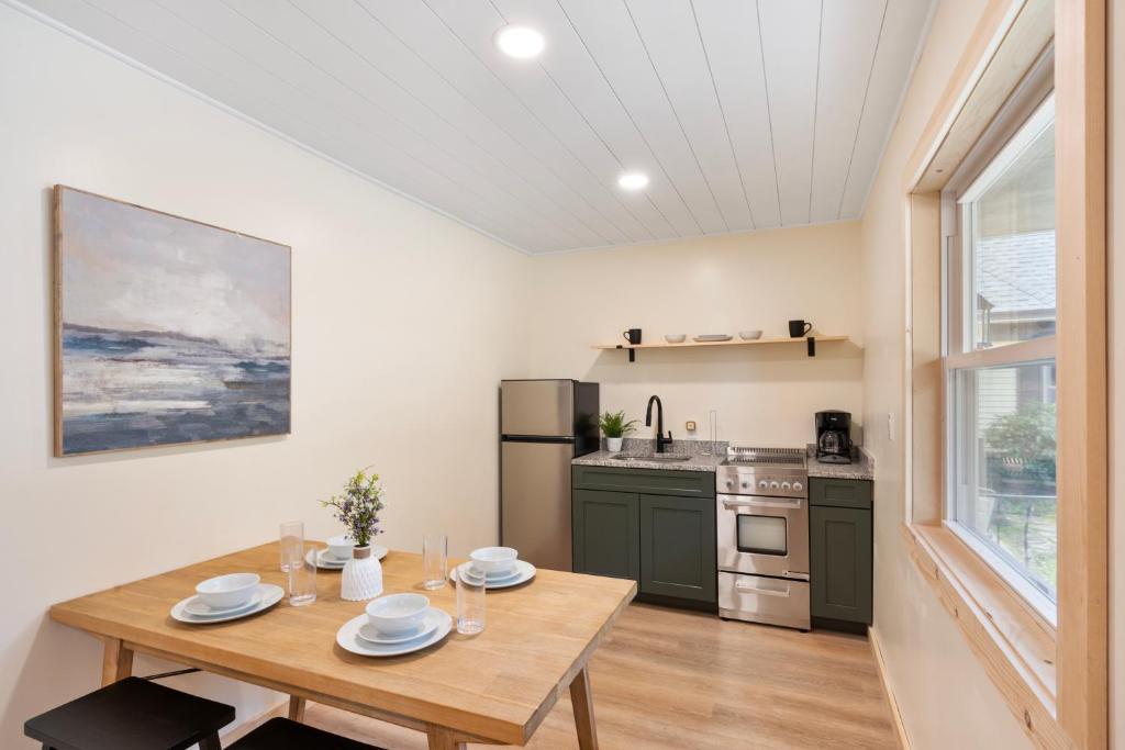 a dining room with a table and a kitchen at Squam Lake 3 bed plus 3 bath rental (Suite 7) in Holderness