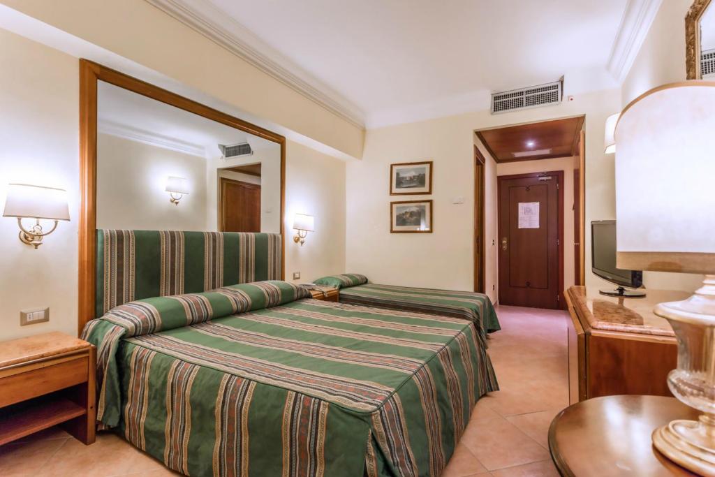 Postel nebo postele na pokoji v ubytování Raeli Hotel Archimede