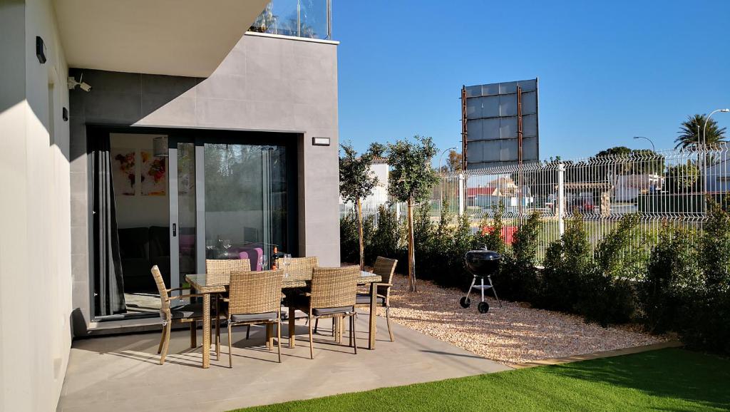 a patio with a table and chairs next to a building at Villa Blanca with private pool - San Javier in San Javier