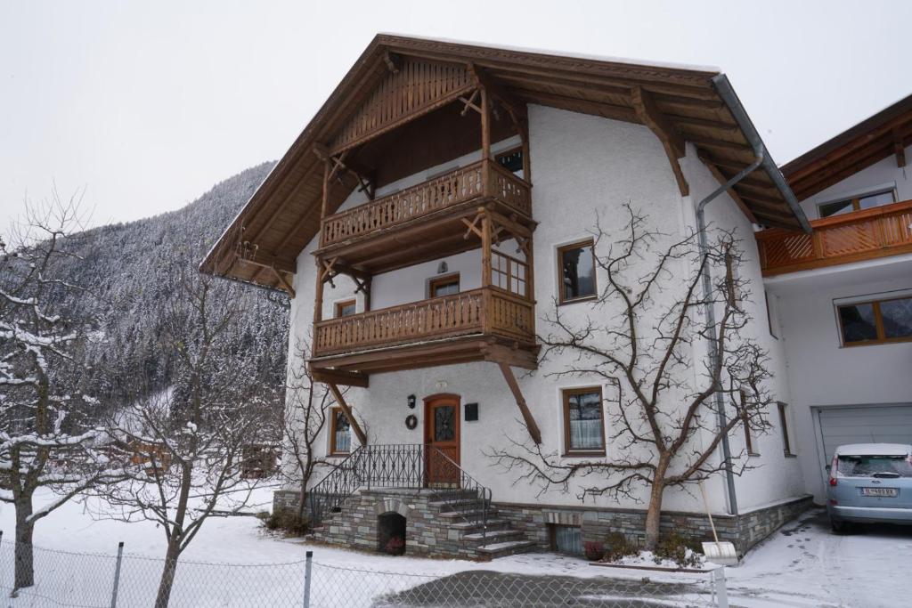 a house with a wooden balcony on top of it at Haus Ruetzbach in Neustift im Stubaital