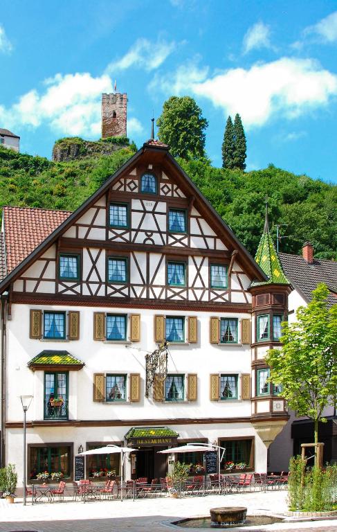 a building with a mountain in the background at Hotel & Restaurant Adler in Hornberg