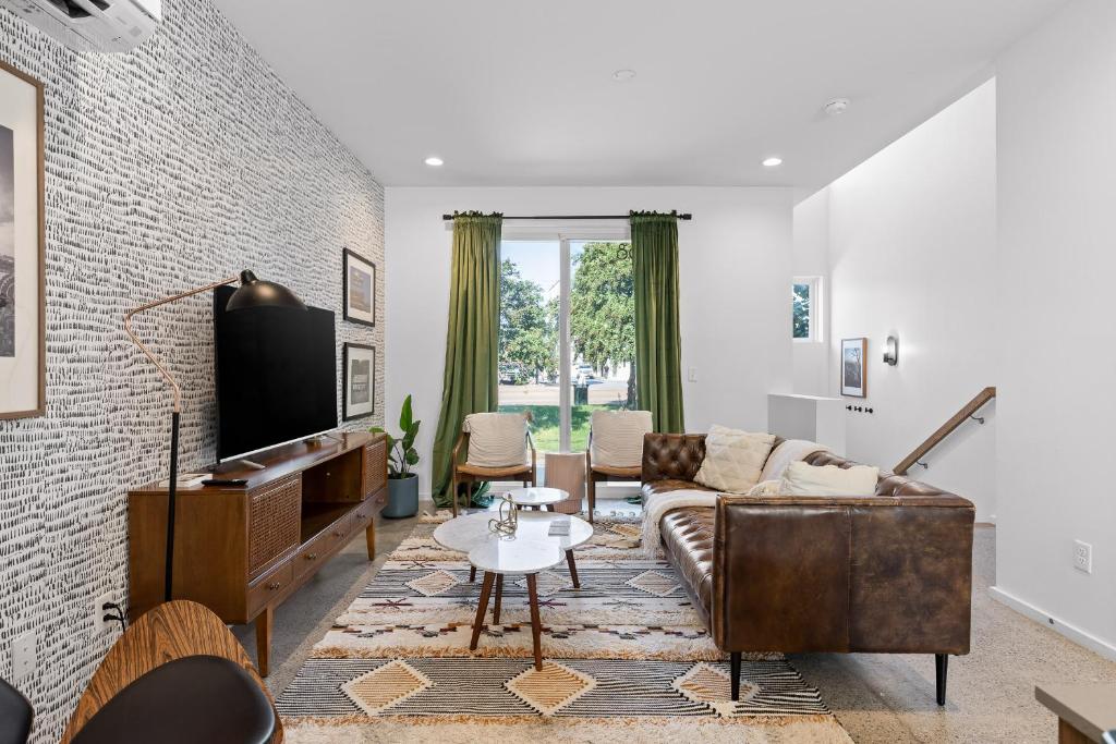 a living room with a couch and a tv at South Side Modern - Downtown Living - Amazing Location in Chattanooga