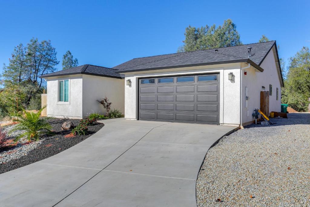 a house with a garage and a driveway at 5 Mi to Shasta Lake Newly Built Home with Backyard! in Shasta Lake