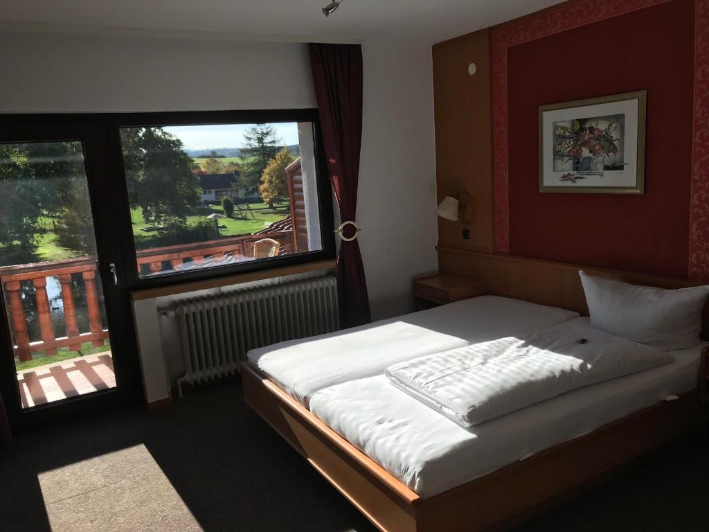 Postel nebo postele na pokoji v ubytování Hotel Wettlaufer