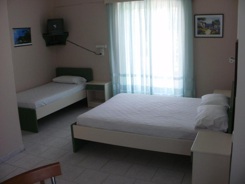 Postel nebo postele na pokoji v ubytování Triantis Apartments