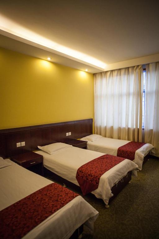 Postel nebo postele na pokoji v ubytování Huangshan Tangkou Haoshi International Youth Hostel