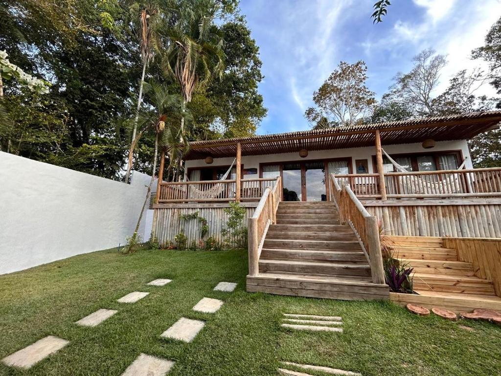 una casa con una escalera de madera en el patio en Casa Rubi Trancoso, en Porto Seguro