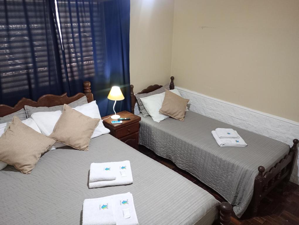 two beds sitting next to each other in a room at Temporario Del Centro in Paso de los Libres