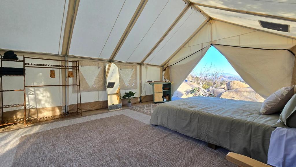 a room with a tent with a bed in it at A Cozy Sunrise Glamping Escape with Panoramic View in Fallbrook