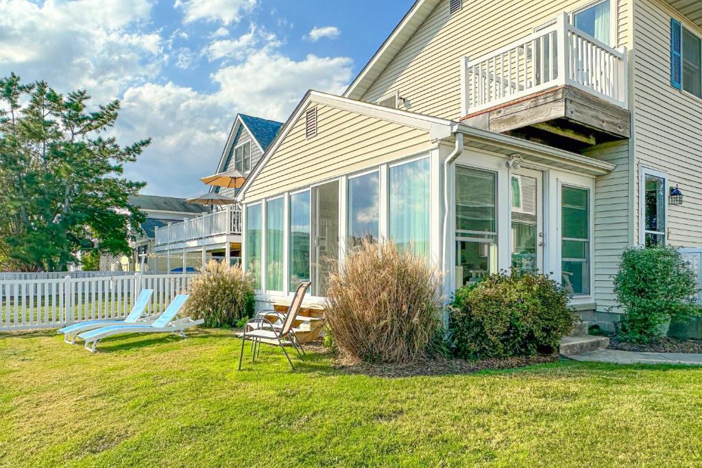 a house with glass doors and chairs in the yard at South Bethany --- 104 Brandywine St in Bethany Beach