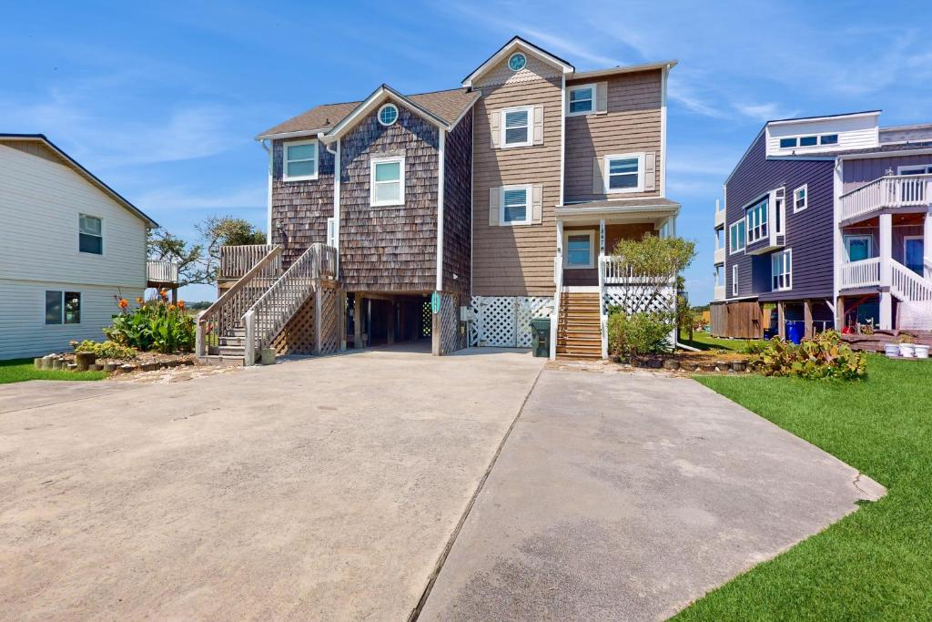 a large house with a staircase in a driveway at Carolina Sunshine Waterfront in North Topsail Beach