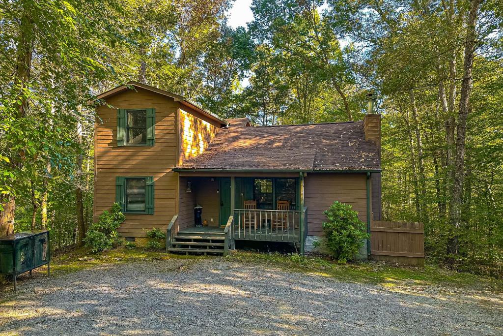 a small house with a porch in the woods at Four Seasons Retreat in Townsend
