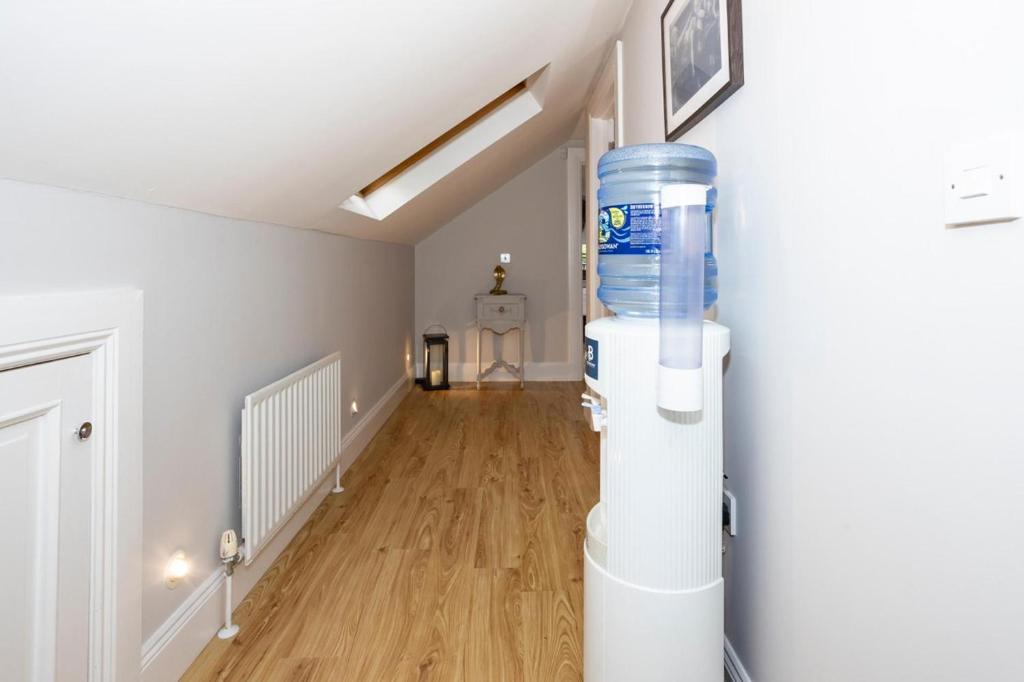 an empty living room with a water cooler in a room at Ravensdale Retreat Dundalk in Dundalk