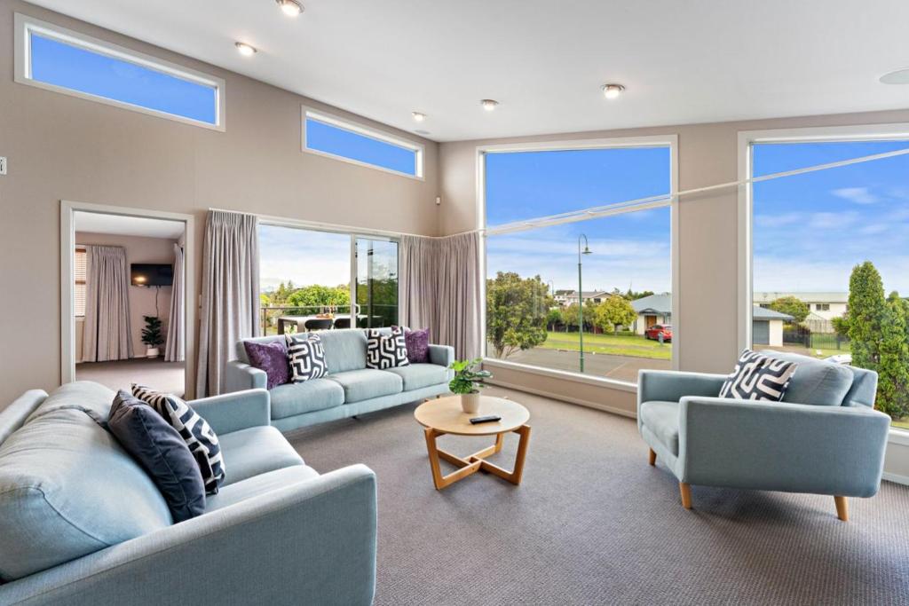 a large living room with couches and a table at Holiday Home Lake Taupo in Taupo