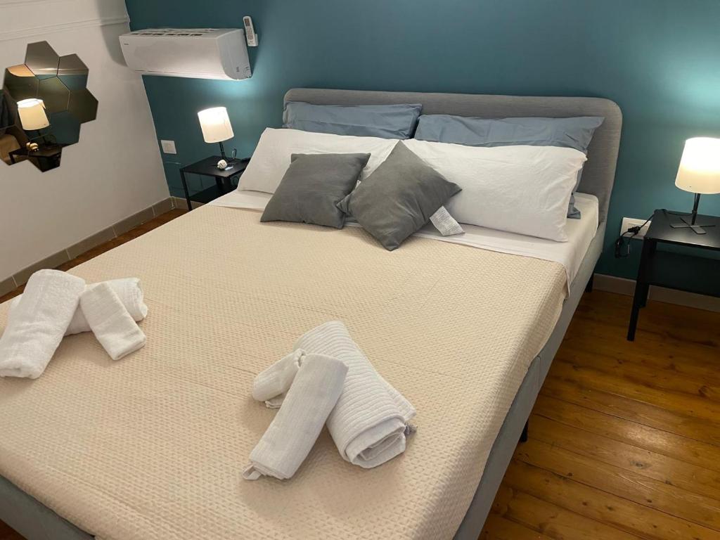 a bedroom with a bed with towels on it at casa catania termini home 3 in Catania